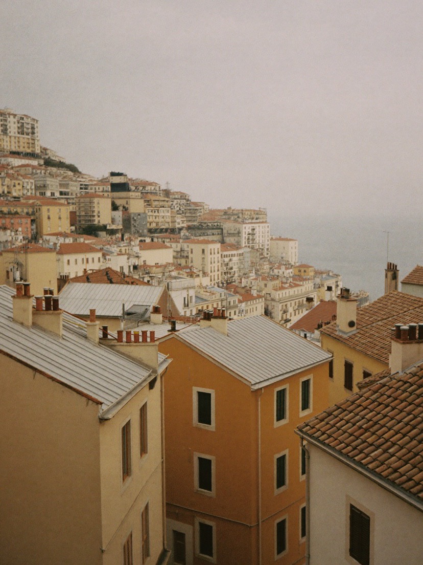 Pastel rooftops on a Lisbon hillside above the water